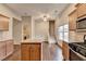 Open kitchen with island, stainless steel appliances, and a view of the staircase at 2506 Creek Station Dr, Buford, GA 30519
