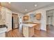 Spacious kitchen with stainless steel appliances, a granite island, and hardwood floors at 2506 Creek Station Dr, Buford, GA 30519