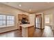 Bright kitchen features stainless appliances, center island and beautiful hardwood floors at 2506 Creek Station Dr, Buford, GA 30519