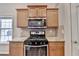 Close-up of kitchen featuring stainless steel appliances, granite counters, and wooden cabinets at 2506 Creek Station Dr, Buford, GA 30519