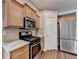 Close-up of kitchen with gas range, stainless appliances, and granite countertops at 2506 Creek Station Dr, Buford, GA 30519