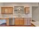 Bright kitchen features a stainless steel dishwasher, granite countertops, and wooden cabinetry at 2506 Creek Station Dr, Buford, GA 30519