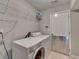 Functional laundry room with washer, dryer, shelving and diamond plate door protection at 2506 Creek Station Dr, Buford, GA 30519