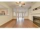 Spacious living room boasts hardwood floors, a cozy fireplace, and seamless transition into the kitchen at 2506 Creek Station Dr, Buford, GA 30519
