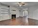 Open-concept living room with hardwood floors, a fireplace, and stylish built-in cabinets, perfect for entertaining at 2506 Creek Station Dr, Buford, GA 30519