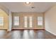 Living room with hardwood floors and french doors leading to the backyard at 2506 Creek Station Dr, Buford, GA 30519
