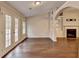 Open floor plan with a fireplace, built-in shelving, and access to backyard at 2506 Creek Station Dr, Buford, GA 30519