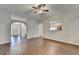 Bright living room featuring hardwood floors, ceiling fan, and view of the entry at 2506 Creek Station Dr, Buford, GA 30519