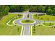 Aerial view of a meticulously designed neighborhood roundabout with manicured landscaping at 8588 Secretariat Dr, Lithonia, GA 30058