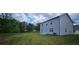 The backyard offers a green space and view of the home's exterior at 8588 Secretariat Dr, Lithonia, GA 30058