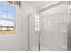 Bathroom featuring a large window and separate glass enclosed shower at 8588 Secretariat Dr, Lithonia, GA 30058