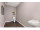 Stylish powder room with a sleek floating sink and modern fixtures in a neutral color palette at 8588 Secretariat Dr, Lithonia, GA 30058