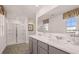 Bright bathroom with dual sinks, marble countertops, and a glass-enclosed shower at 8588 Secretariat Dr, Lithonia, GA 30058