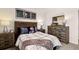A bedroom with wooden furniture, Atlanta-themed decorations, and neutral tones for a cozy and modern look at 8588 Secretariat Dr, Lithonia, GA 30058