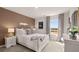 Stylish bedroom featuring a white sleigh bed, modern decor, and a large bright window at 8588 Secretariat Dr, Lithonia, GA 30058