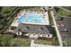 Aerial view of a community pool area with ample seating, a clubhouse, and a parking area at 8588 Secretariat Dr, Lithonia, GA 30058