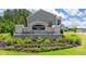 Stone entrance sign for Champions Run surrounded by lush landscaping on a sunny day at 8588 Secretariat Dr, Lithonia, GA 30058