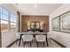 Elegant dining room with modern chairs, a decorative table setting, and a large window view at 8588 Secretariat Dr, Lithonia, GA 30058