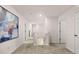 Upstairs hallway with neutral carpet features a statement piece of art and natural light at 8588 Secretariat Dr, Lithonia, GA 30058