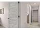 Bright hallway with multiple doors for bedrooms and closets; features neutral paint and carpet at 8588 Secretariat Dr, Lithonia, GA 30058