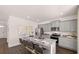 Open kitchen with stainless appliances, grey cabinets, eat-in island, and stylish pendant lighting at 8588 Secretariat Dr, Lithonia, GA 30058