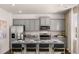 Stylish kitchen features modern gray cabinets, granite countertops and eat-in bar at 8588 Secretariat Dr, Lithonia, GA 30058