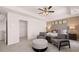 Elegant main bedroom with a seating area, plush headboard, and a decorative ceiling fan at 8588 Secretariat Dr, Lithonia, GA 30058