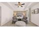 Inviting main bedroom featuring a tray ceiling, plush seating, and a tufted headboard at 8588 Secretariat Dr, Lithonia, GA 30058