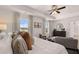 Spacious main bedroom with tray ceilings, plush bedding, and natural light at 8588 Secretariat Dr, Lithonia, GA 30058