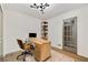 A bright home office with hardwood floors, modern lighting, and glass paneled door at 1335 Chaucer Ne Ln, Brookhaven, GA 30319