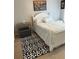This comfortable bedroom features a white wood frame bed, neutral walls, and black and white rug at 179 Silver Arrow Cir, Austell, GA 30168