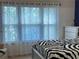 Serene bedroom with large windows, sheer curtains, and zebra print comforter at 179 Silver Arrow Cir, Austell, GA 30168