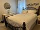 This cozy bedroom features an iron scroll bed frame, white bedding and floral accent pieces at 179 Silver Arrow Cir, Austell, GA 30168
