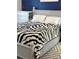 Comfortable bedroom features white wood trim, stylish zebra print throw and neutral walls at 179 Silver Arrow Cir, Austell, GA 30168
