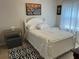 This comfortable bedroom features a white wood frame bed, neutral walls, and black and white rug at 179 Silver Arrow Cir, Austell, GA 30168