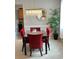 Elegant dining room with a modern chandelier, red velvet chairs, and a view into kitchen at 179 Silver Arrow Cir, Austell, GA 30168