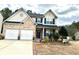 Charming two-story home featuring a brick facade, two-car garage, and manicured front yard at 179 Silver Arrow Cir, Austell, GA 30168