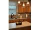 A kitchen island with modern lighting over a sink with faucet at 179 Silver Arrow Cir, Austell, GA 30168