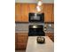 Kitchen with wooden cabinets, island and stainless steel microwave at 179 Silver Arrow Cir, Austell, GA 30168