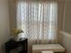 Sunlit room with a view features patterned window curtains, a love seat, and black accent table at 179 Silver Arrow Cir, Austell, GA 30168