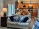 Inviting living space featuring a cozy couch and kitchen view at 179 Silver Arrow Cir, Austell, GA 30168
