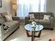 Comfortable living room with sofas, sheer curtains, and glass top coffee table at 179 Silver Arrow Cir, Austell, GA 30168