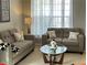 Comfortable living room with sofas, sheer curtains, and glass top coffee table at 179 Silver Arrow Cir, Austell, GA 30168