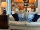 Comfortable living room with cozy couch, throw pillows, and modern lamp at 179 Silver Arrow Cir, Austell, GA 30168