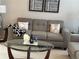Cozy living room featuring a comfortable sofa, glass coffee table, and stylish decor at 179 Silver Arrow Cir, Austell, GA 30168
