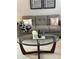 Cozy living room featuring a comfortable sofa, glass coffee table, and stylish decor at 179 Silver Arrow Cir, Austell, GA 30168