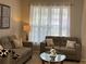 Comfortable living room with sofas, sheer curtains, and glass top coffee table at 179 Silver Arrow Cir, Austell, GA 30168