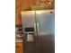 Stainless steel refrigerator with built-in water dispenser and wooden cabinets at 179 Silver Arrow Cir, Austell, GA 30168