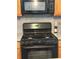 Modern kitchen featuring a gas stove, microwave and neutral backsplash at 179 Silver Arrow Cir, Austell, GA 30168