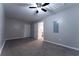 Bedroom with neutral carpet, ceiling fan, two doors, and neutral paint at 1940 Matthew Way, Lithonia, GA 30058